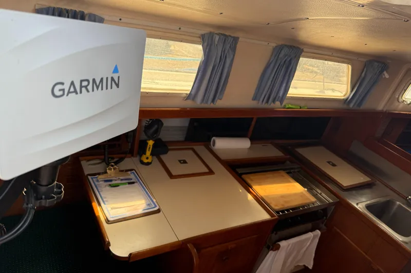 Slide: The Image of Interior of 1984 Aloha 32 sailboat with Garmin equipment and kitchen area. - 13
