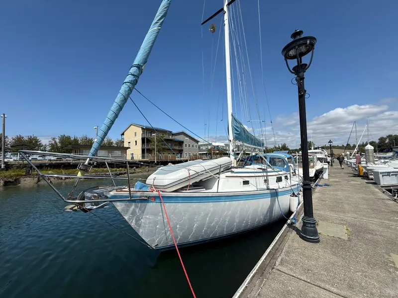 Slide: The Image of 1984 Aloha 32 sailboat docked at marina under clear blue sky. - 3
