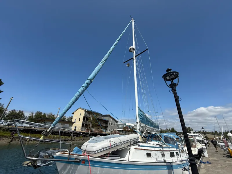 Slide: The Image of 1984 Aloha 32 sailboat docked under clear blue sky. - 4
