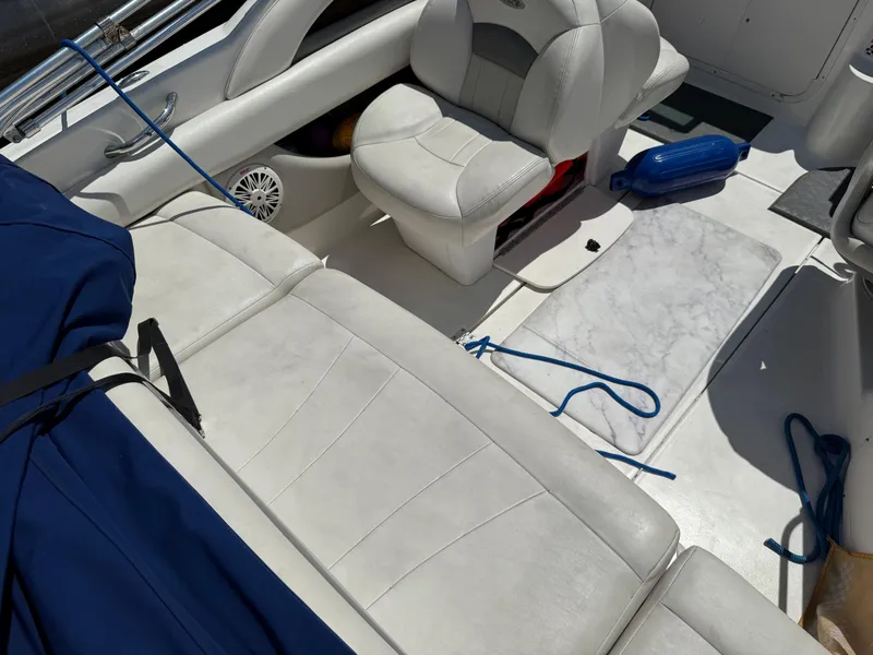 Slide: The Image of Interior of a 2007 Chaparral 215 SSi boat with white seating and blue accessories. - 10