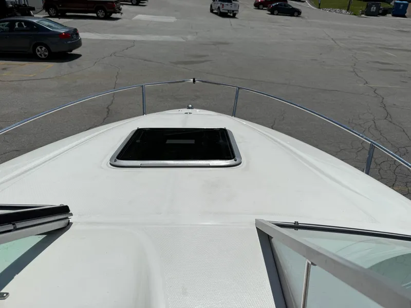 Slide: The Image of 2007 Chaparral 215 SSi boat deck with open hatch, parked in a lot. - 17