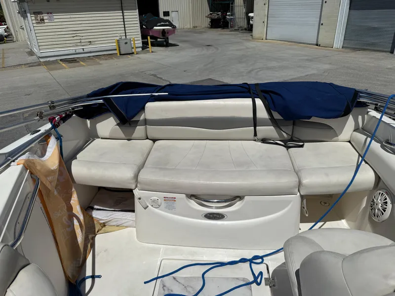 Slide: The Image of 2007 Chaparral 215 SSi boat interior with white seating and blue cover. - 18