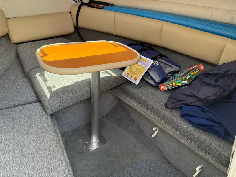 Slide: The Image of 2007 Chaparral 215 SSi boat interior with table, seating, and life jackets. - 20