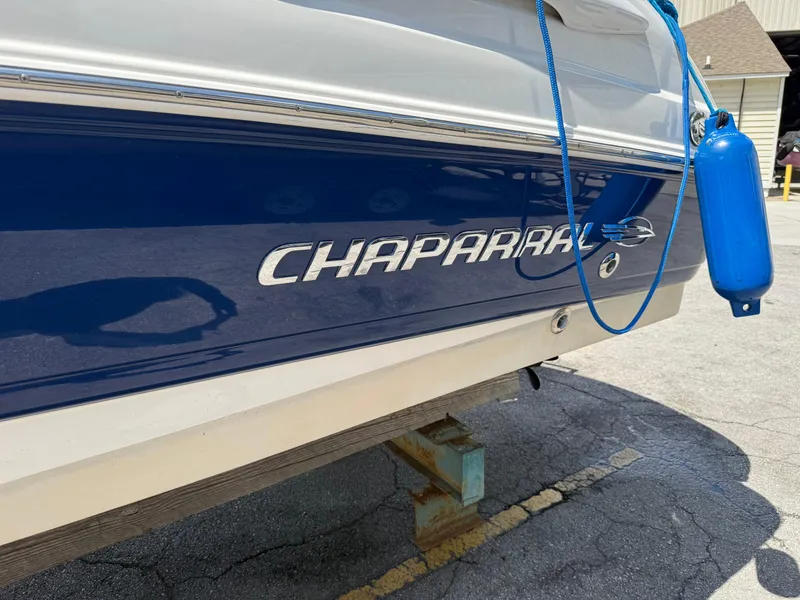 Slide: The Image of 2007 Chaparral 215 SSi boat with blue hull and dock fender. - 7