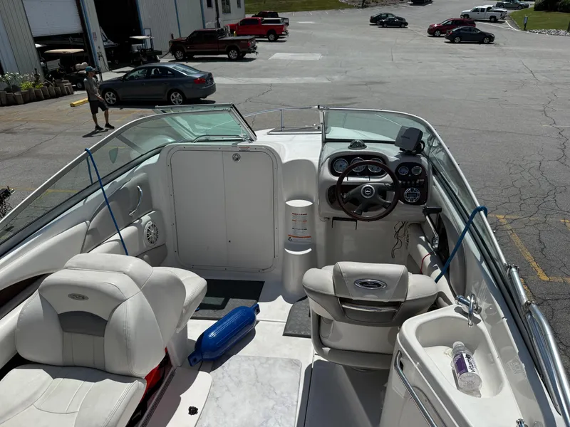 Slide: The Image of 2007 Chaparral 215 SSi boat interior with steering wheel, seats, and dashboard in a parking lot. - 8