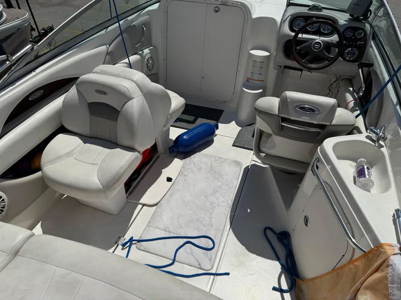 Slide: The Image of 2007 Chaparral 215 SSi boat interior with white seating, steering wheel, and dashboard. - 9