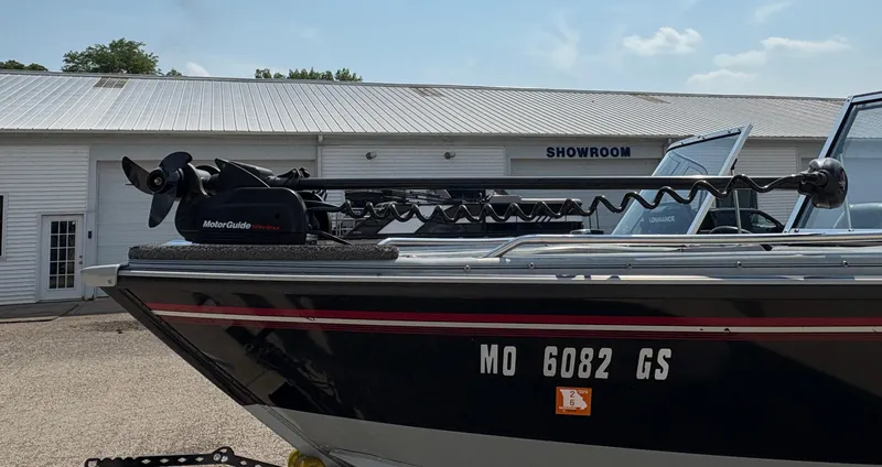 Slide: The Image of 2001 Lund 1950 Tyee Magnum GS boat with MotorGuide trolling motor, parked near showroom. - 10