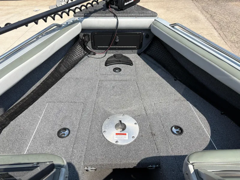 Slide: The Image of 2001 Lund 1950 Tyee Magnum GS ITS boat interior with carpeted deck and storage compartments. - 13