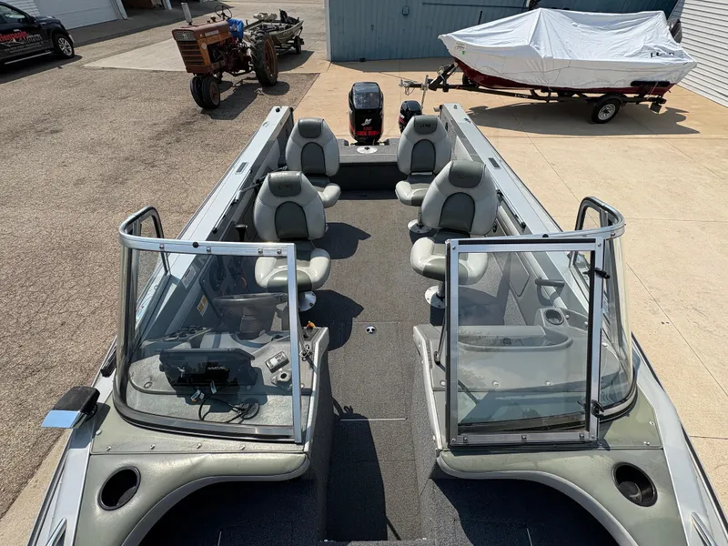 Slide: The Image of 2001 Lund 1950 Tyee Magnum GS ITS boat with seating and windshield, parked outdoors. - 17