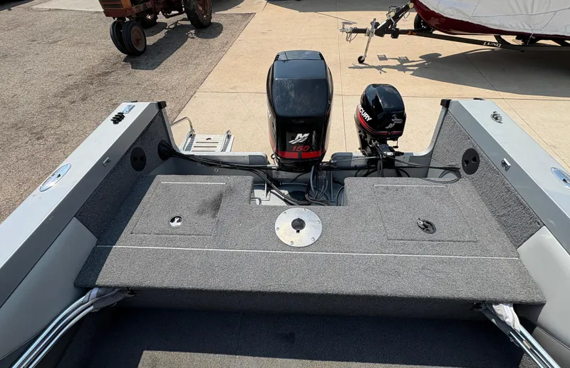 Slide: The Image of 2001 Lund 1950 Tyee Magnum GS ITS boat with dual outboard motors on a trailer. - 25