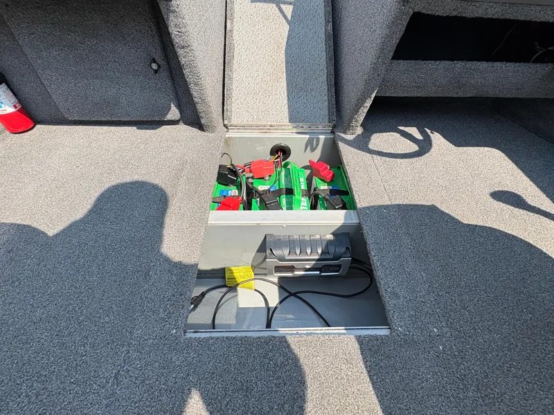 Slide: The Image of Storage compartment in a 2001 Lund 1950 Tyee Magnum GS ITS boat, containing batteries and cables. - 32