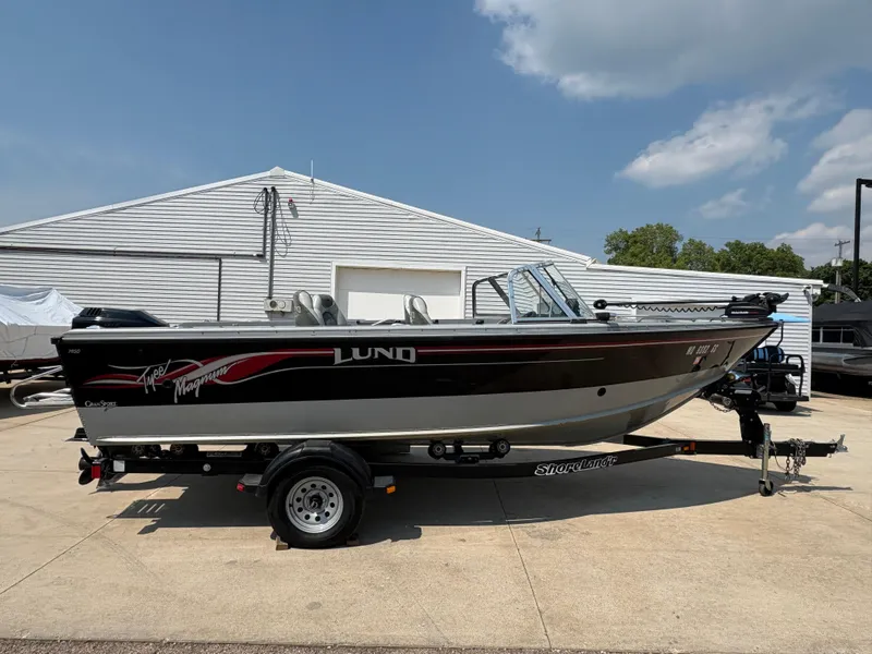 Slide: The Image of 2001 Lund 1950 Tyee Magnum GS ITS boat on trailer, parked outdoors. - 5