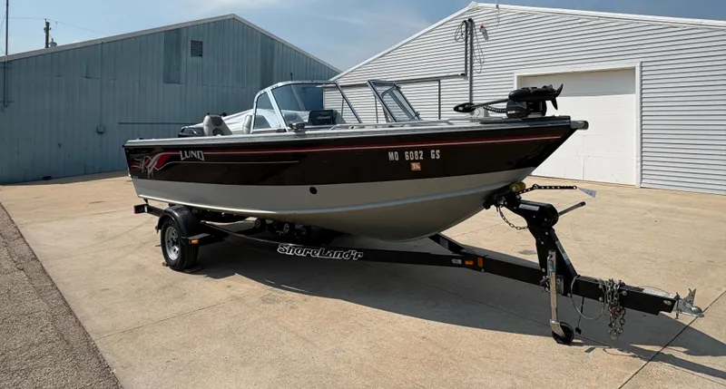 Slide: The Image of 2001 Lund 1950 Tyee Magnum GS ITS boat on trailer, parked outside a building. - 6