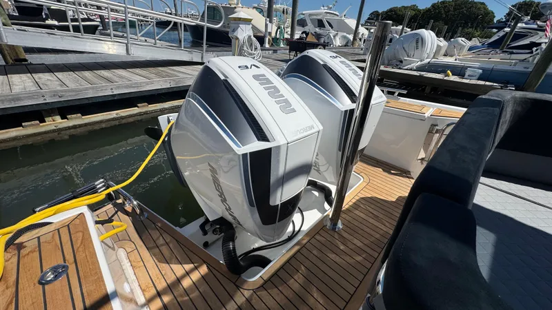Slide: The Image of Twin Nimbus T9 outboard motors on a luxury boat docked at a marina, 2025 model. - 13