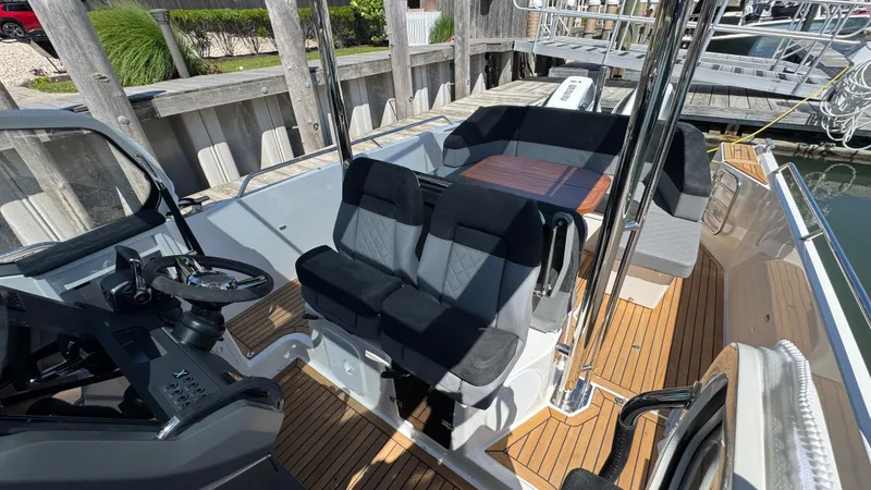 Slide: The Image of 2025 Nimbus T9 boat interior with modern seating and sleek steering console. - 27