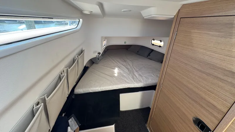 Slide: The Image of Cozy cabin interior of 2025 Nimbus T9 boat with bed and storage. - 29