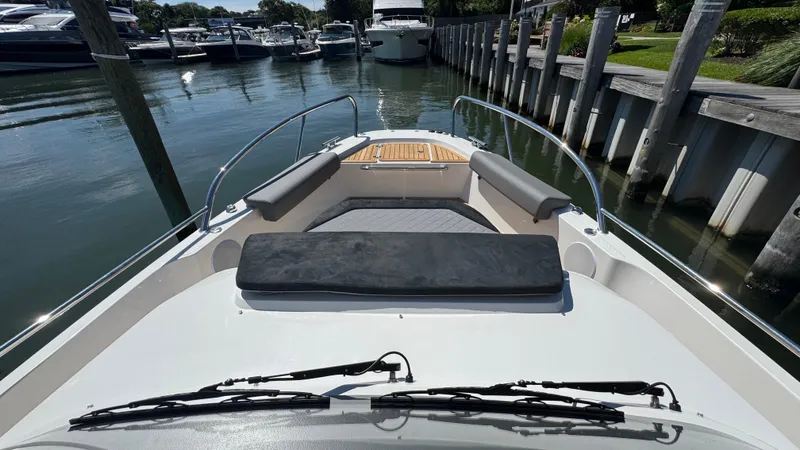 Slide: The Image of Front view of a 2025 Nimbus T9 boat docked in a marina. - 34