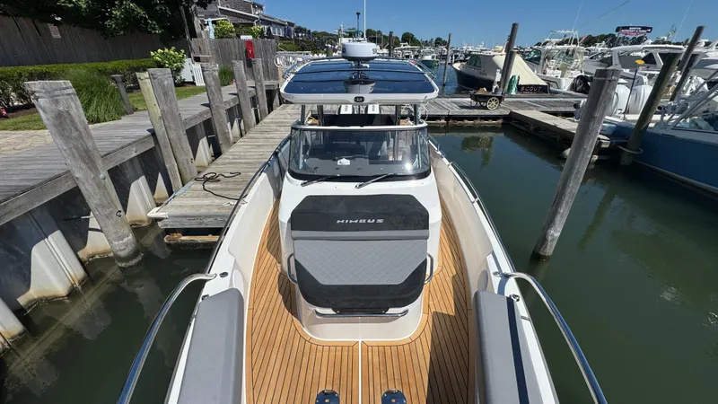 Slide: The Image of Nimbus T9 2025 boat docked at marina, featuring sleek design and wooden deck. - 40