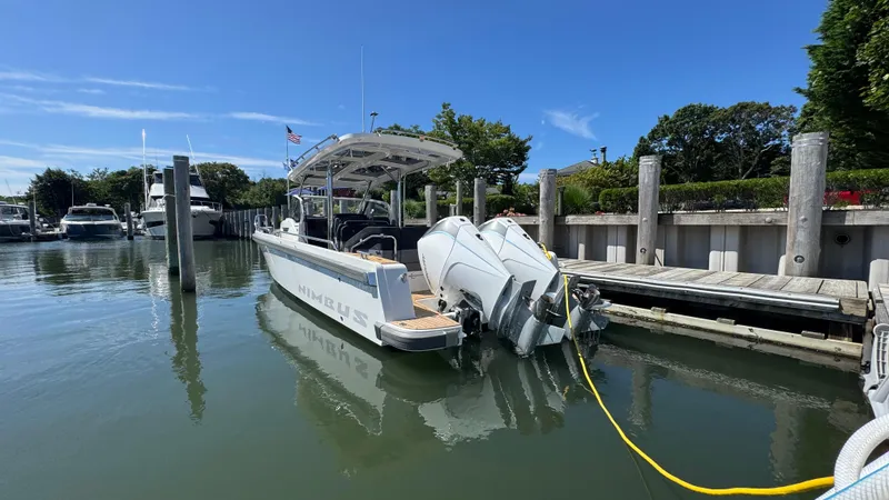 Slide: The Image of Nimbus T9 boat docked at marina, 2025 model, under clear blue sky. - 9