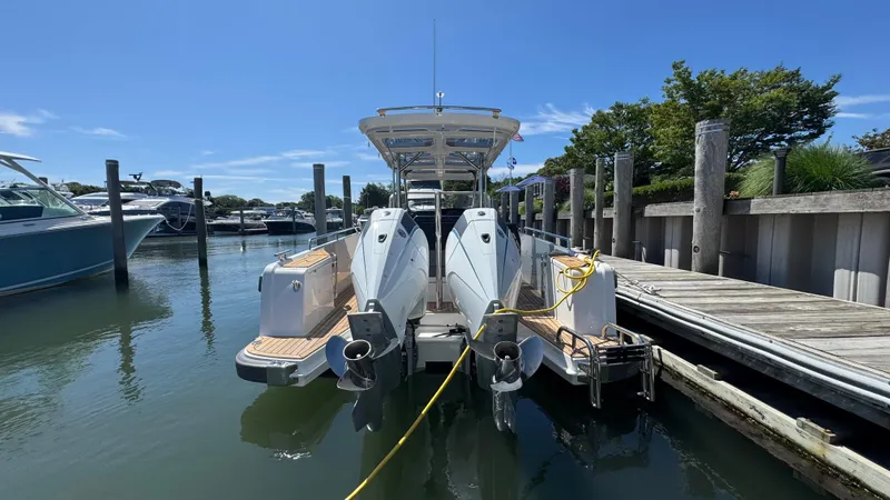 Slide: The Image of 2025 Nimbus T9 boat docked at marina, featuring dual outboard engines. - 11