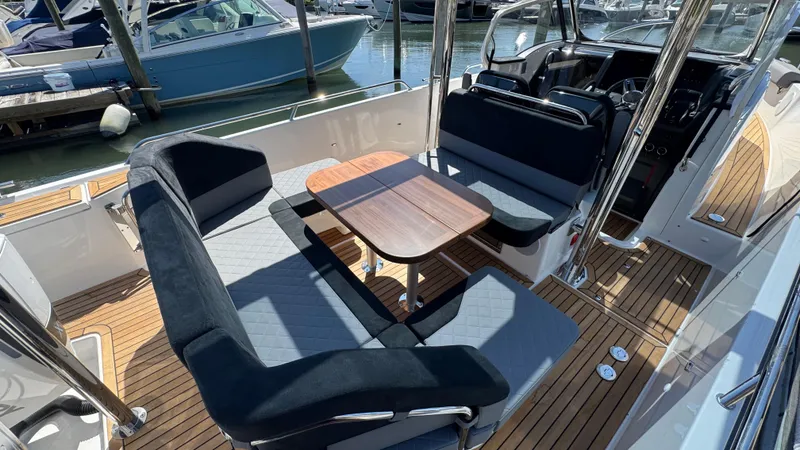 Slide: The Image of Luxurious 2025 Nimbus T9 boat interior with sleek seating and wooden deck. - 19