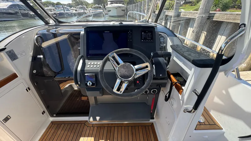 Slide: The Image of Cockpit of 2025 Nimbus T9 boat with modern steering and navigation controls. - 24