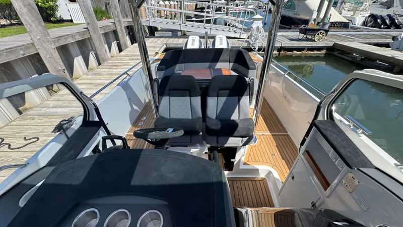 Slide: The Image of Interior view of a 2025 Nimbus T9 boat with sleek seating and wooden deck. - 26