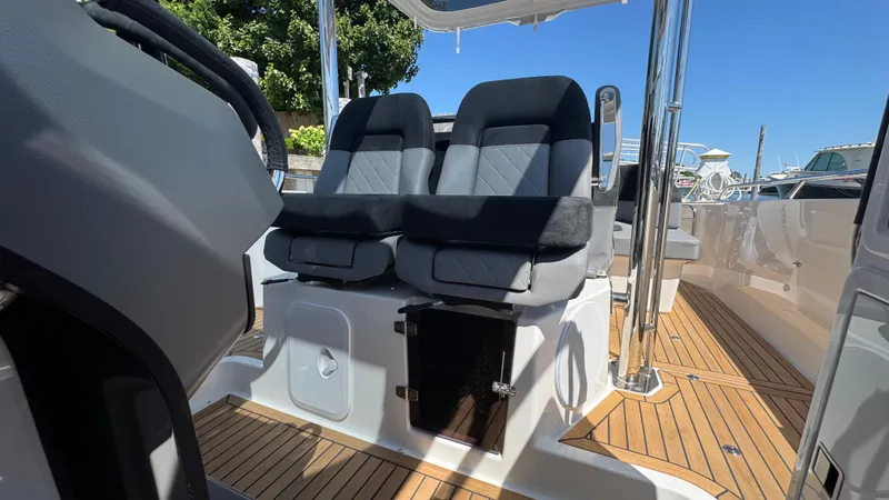 Slide: The Image of Luxury seating on 2025 Nimbus T9 boat with sleek design and wooden deck. - 28
