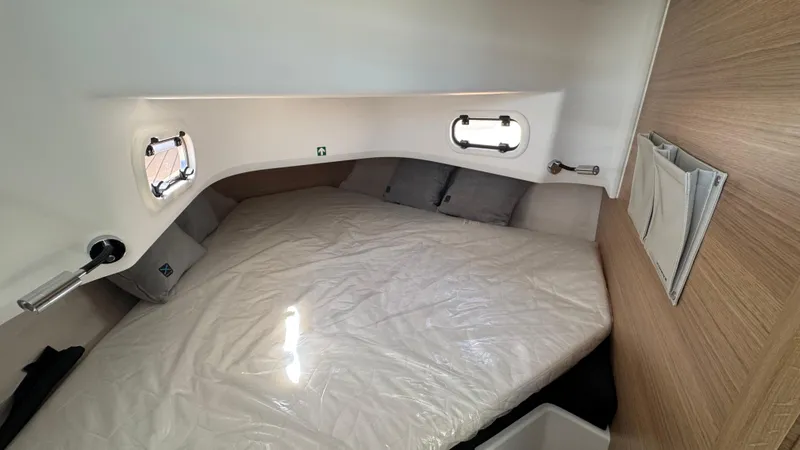 Slide: The Image of Cozy cabin interior of 2025 Nimbus T9 boat with modern design and comfortable bedding. - 30