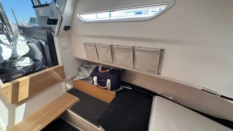 Slide: The Image of Interior of 2025 Nimbus T9 boat with storage compartments and seating area. - 31