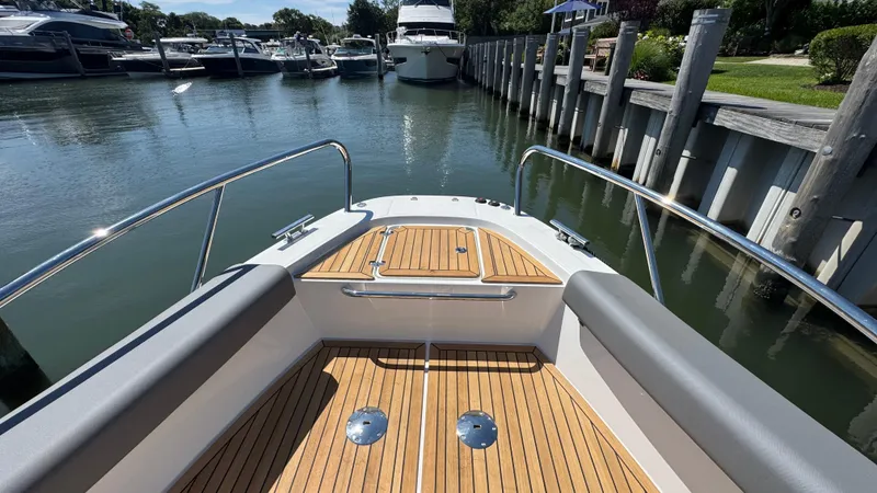 Slide: The Image of Bow view of 2025 Nimbus T9 boat docked in a marina. - 36