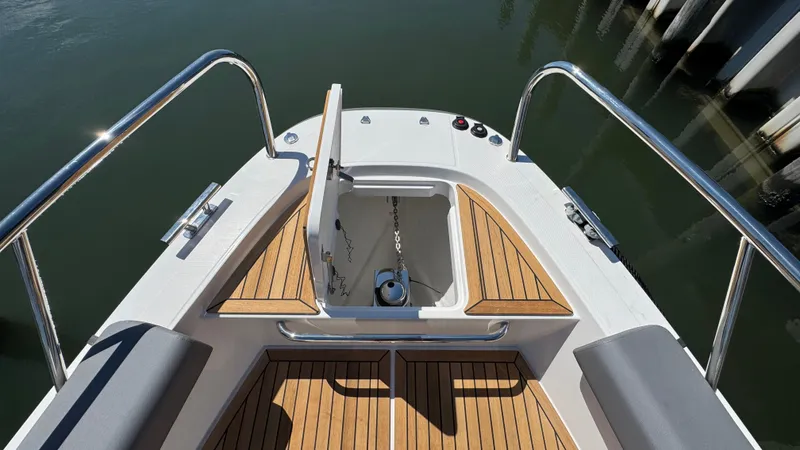 Slide: The Image of Bow view of 2025 Nimbus T9 boat with open anchor compartment. - 37