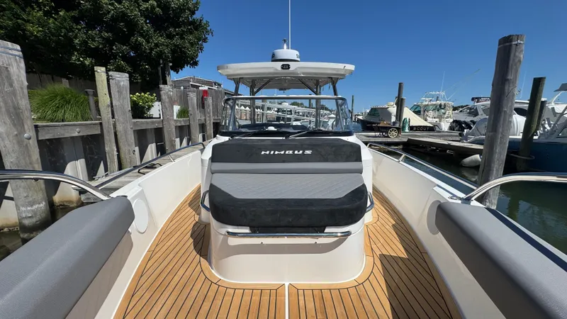 Slide: The Image of 2025 Nimbus T9 boat docked, featuring sleek design and spacious deck. - 39