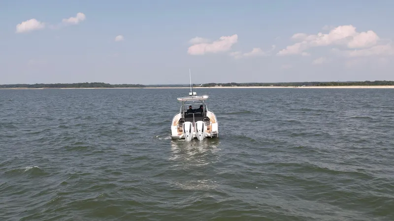 Slide: The Image of Nimbus T9 boat cruising on open water under a clear sky, 2025 model. - 6