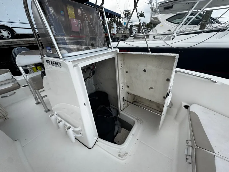 Slide: The Image of 2018 Robalo R180 Center Console boat interior with seating and console view. - 12
