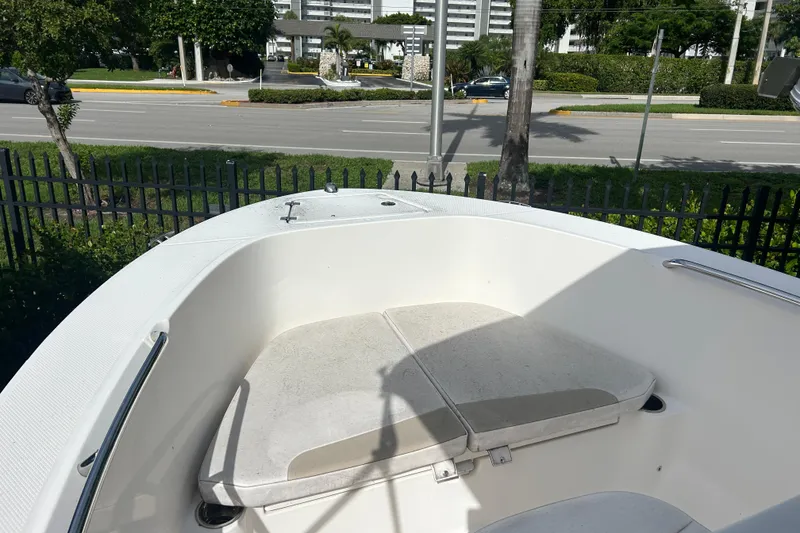 Slide: The Image of 2018 Robalo R180 Center Console boat with open storage compartment and seating area. - 13