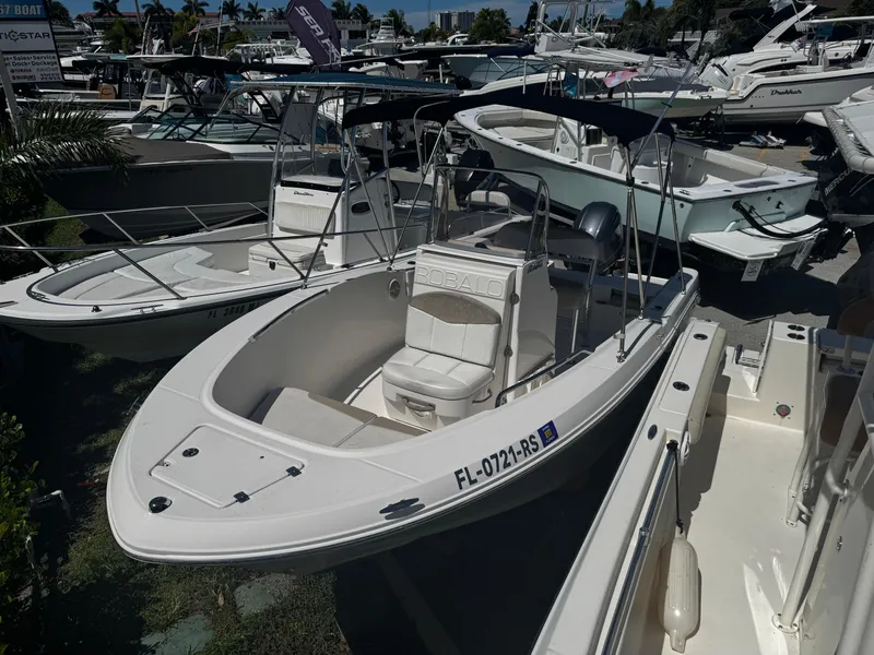 Slide: The Image of 2018 Robalo R180 Center Console boat storage compartment with yellow life jackets. - 16