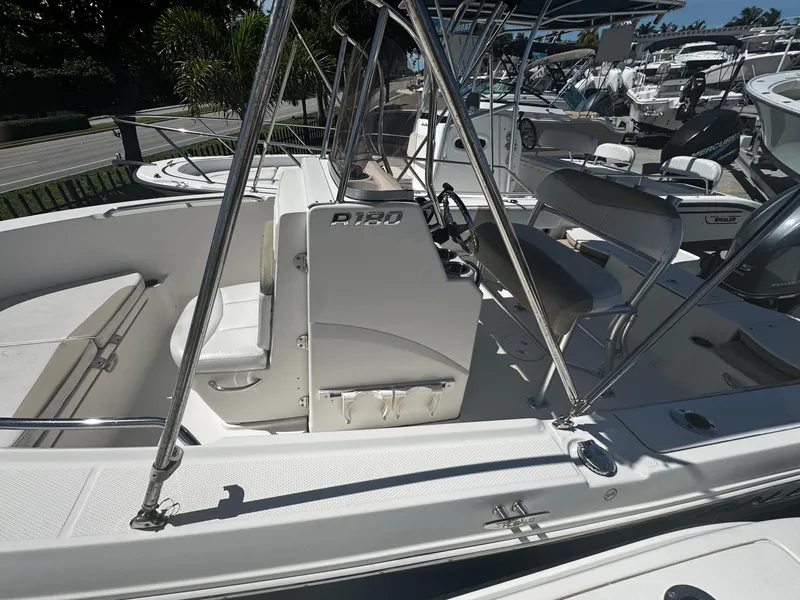 Slide: The Image of 2018 Robalo R180 Center Console boat interior with seating and console view. - 18