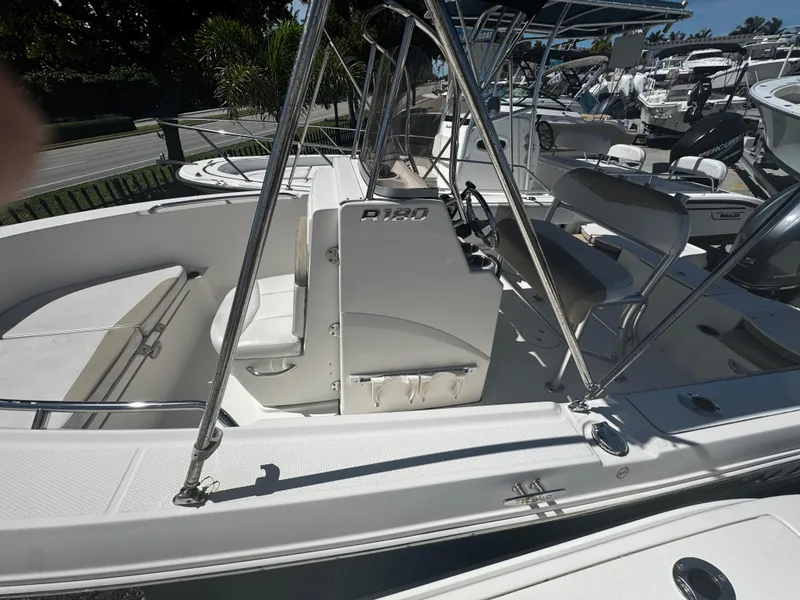 Slide: The Image of 2018 Robalo R180 Center Console boat with seating and steering console. - 19