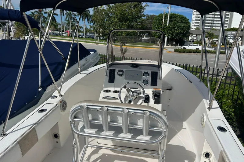 Slide: The Image of 2018 Robalo R180 Center Console boat interior with steering wheel and navigation equipment. - 2