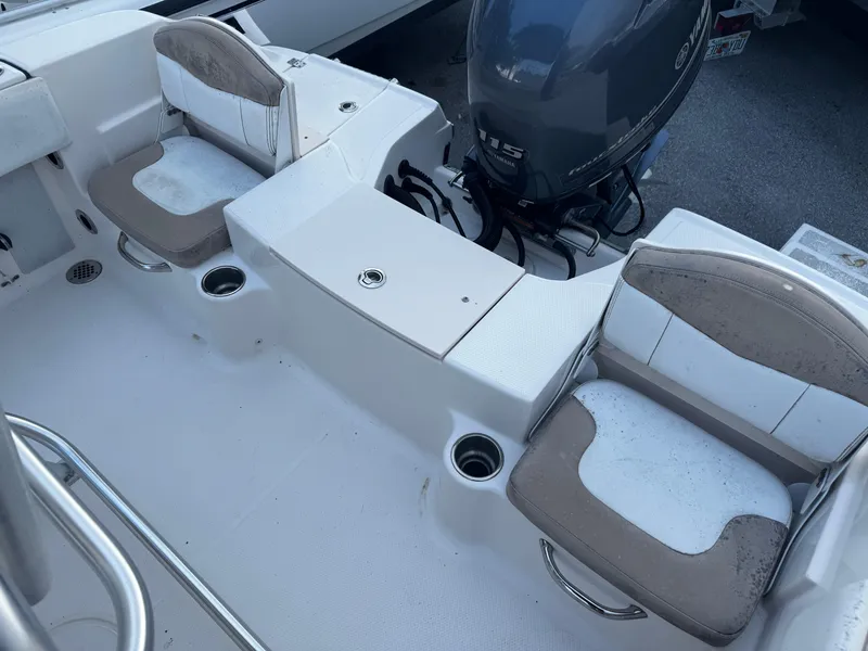 Slide: The Image of 2018 Robalo R180 Center Console boat interior with seating and engine view. - 22