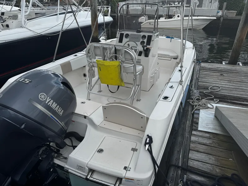Slide: The Image of 2018 Robalo R180 Center Console with Yamaha outboard motor docked at marina. - 25