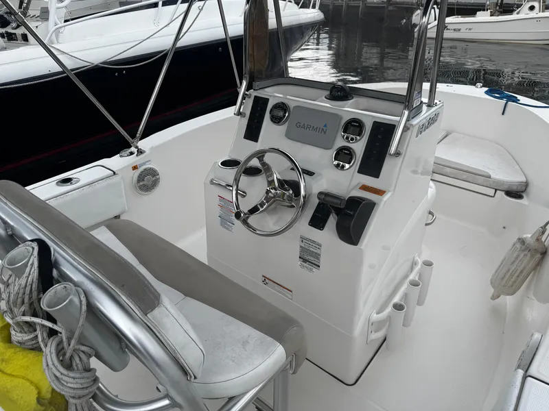 Slide: The Image of 2018 Robalo R180 Center Console boat interior with Garmin navigation system and steering wheel. - 6