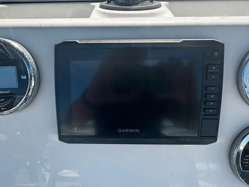 Slide: The Image of 2018 Robalo R180 Center Console boat with Garmin navigation, docked at marina. - 7