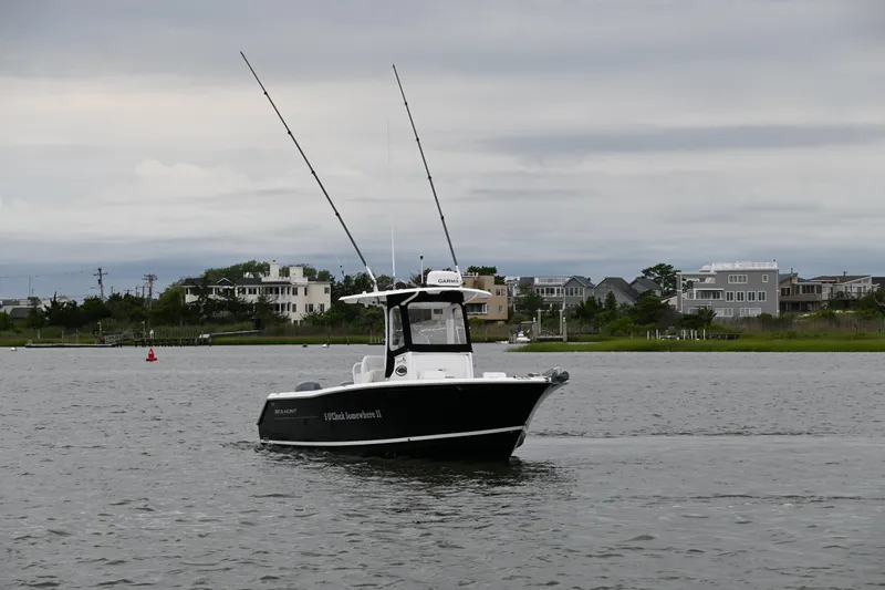 Slide: The Image of 2013 Sea Hunt Gamefish 27 boat on calm water near residential shoreline. - 11