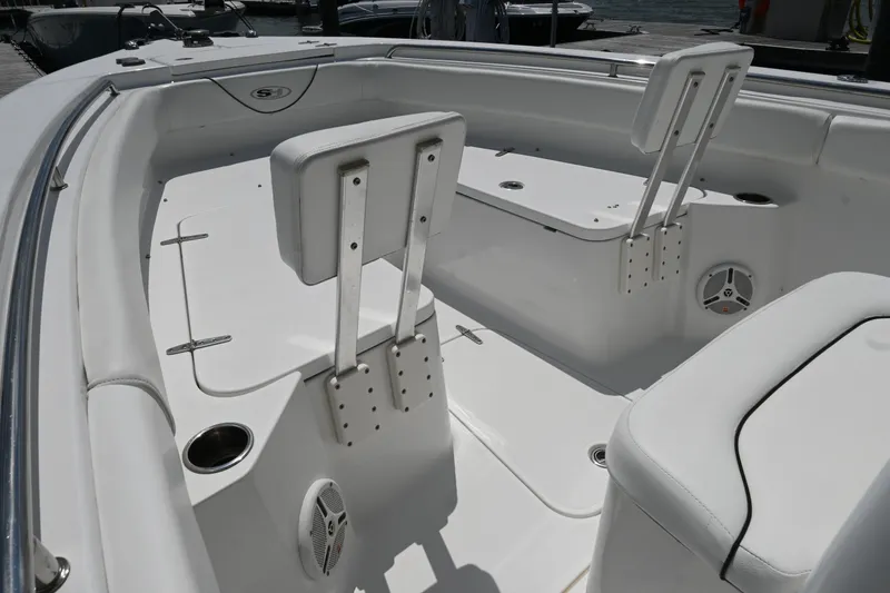 Slide: The Image of 2013 Sea Hunt Gamefish 27 boat interior with white seating and cup holders. - 19