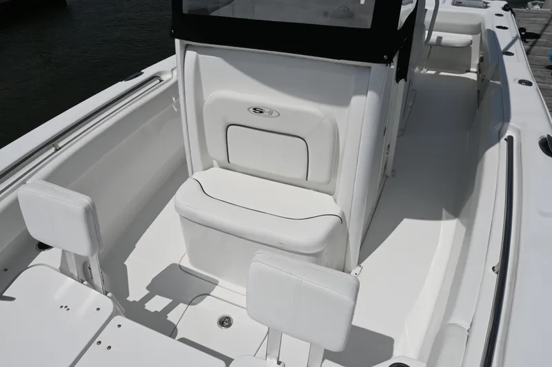 Slide: The Image of 2013 Sea Hunt Gamefish 27 boat interior with white seating and console. - 22