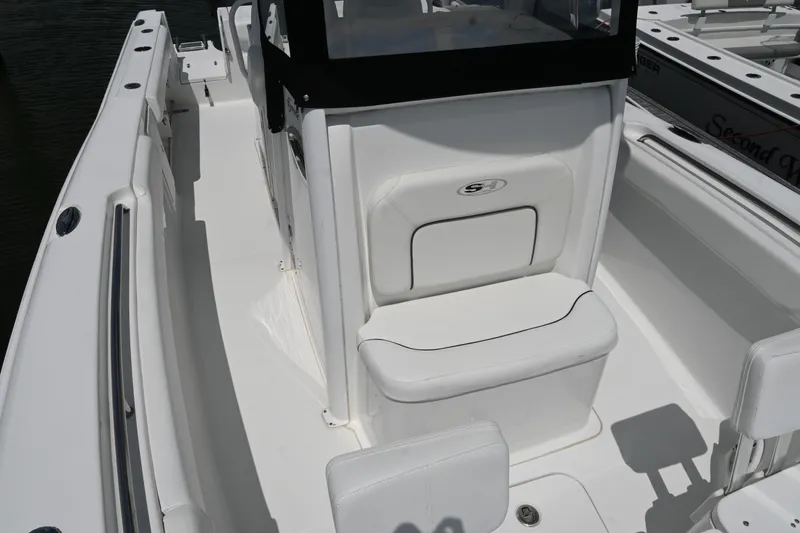 Slide: The Image of 2013 Sea Hunt Gamefish 27 boat interior with white seating and console. - 23