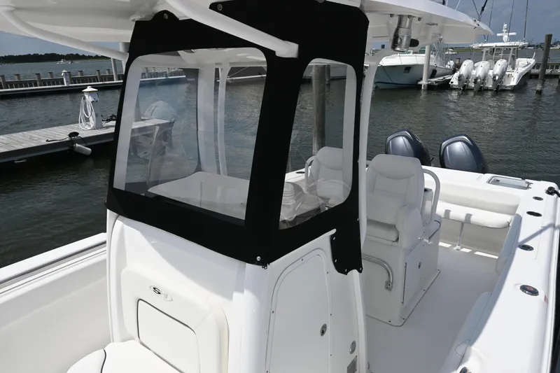 Slide: The Image of 2013 Sea Hunt Gamefish 27 boat docked, featuring dual engines and comfortable seating. - 24