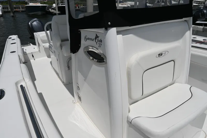 Slide: The Image of 2013 Sea Hunt Gamefish 27 boat interior with seating and console details. - 26